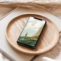 Smartphone with a scenic wallpaper on a wooden plate