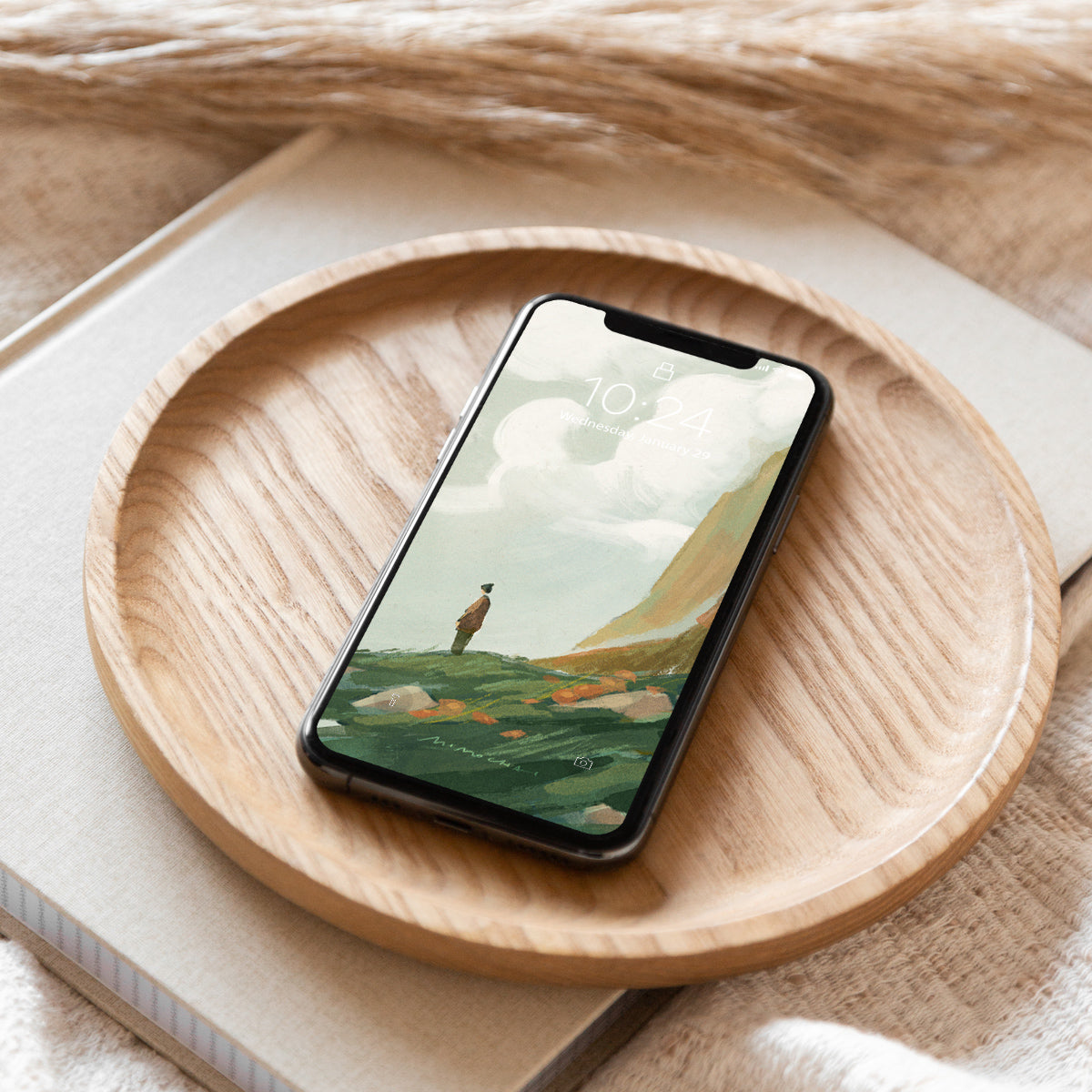 Smartphone with a scenic wallpaper on a wooden plate