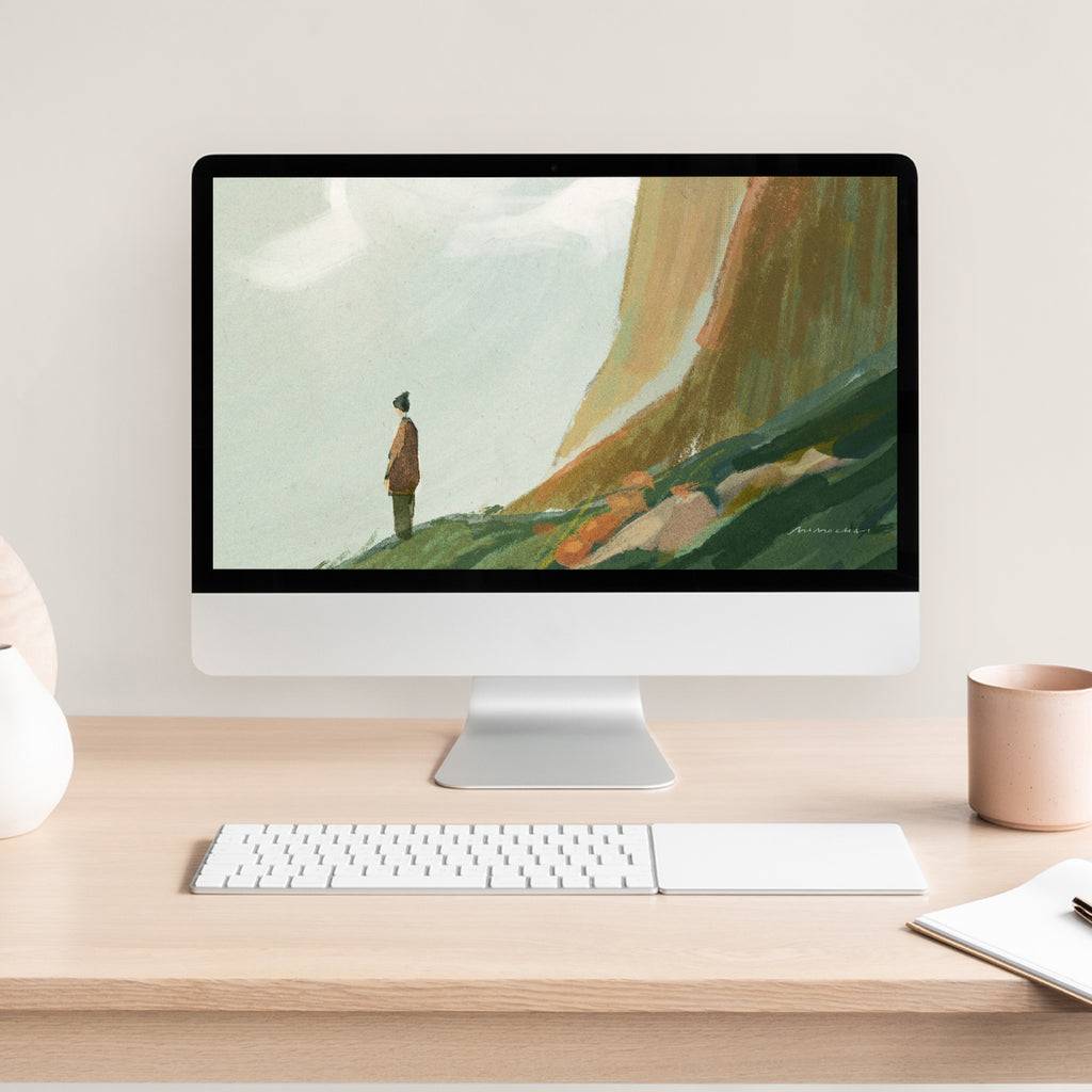 Computer monitor displaying a nature scene on a desk with a keyboard and mug.