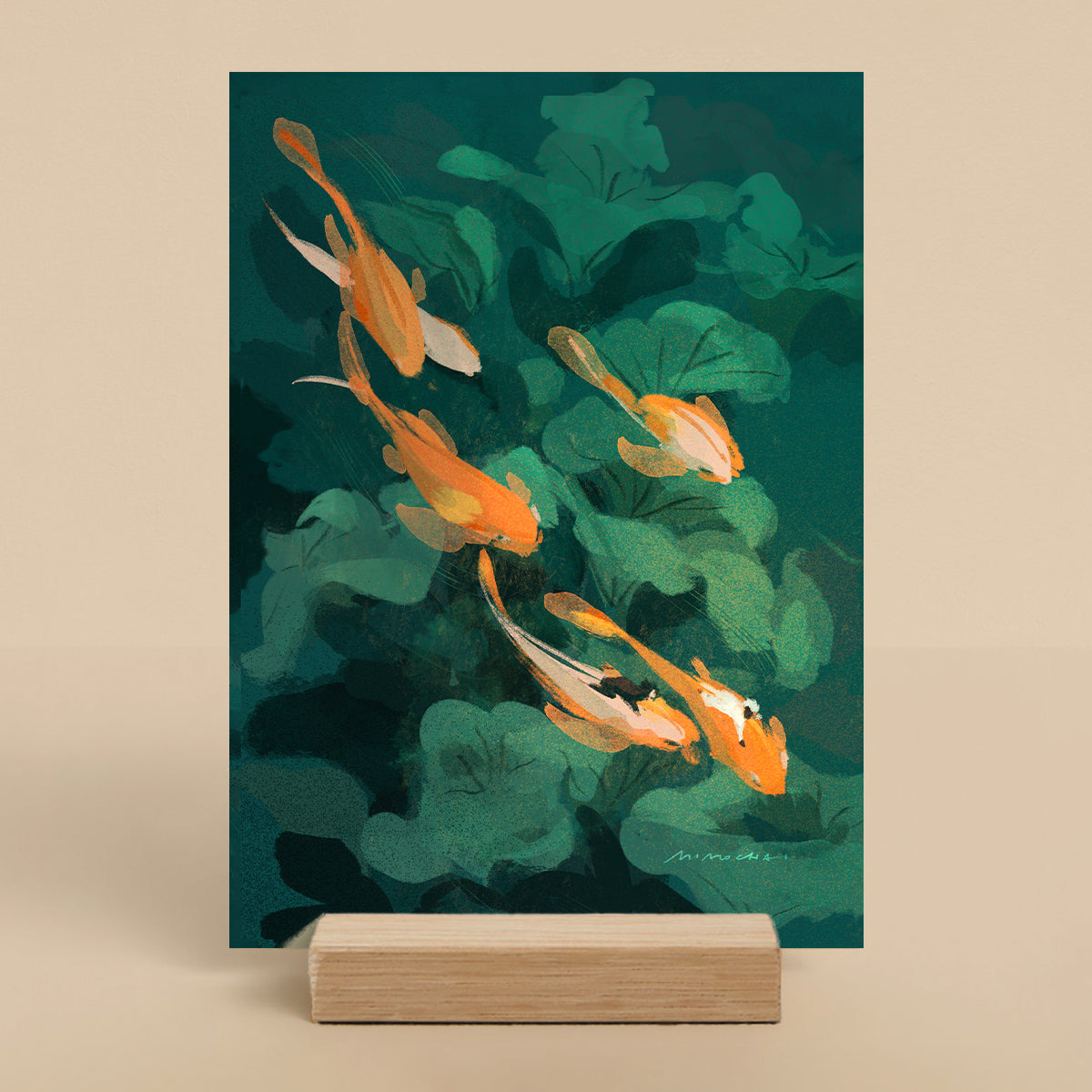 Art print of goldfish swimming among green leaves on a stand with a beige background