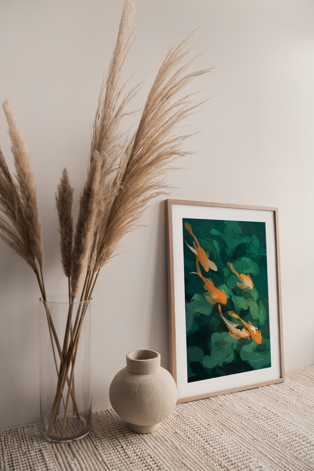 Framed art print of goldfish with green leaves in a calm sunny room.