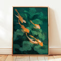 Framed artwork of goldfish and green leaves on a dark green background in a bright sunny room. 
