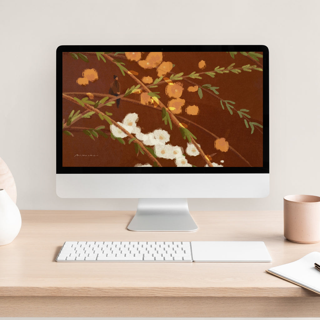 Computer monitor with floral wallpaper on a wooden desk