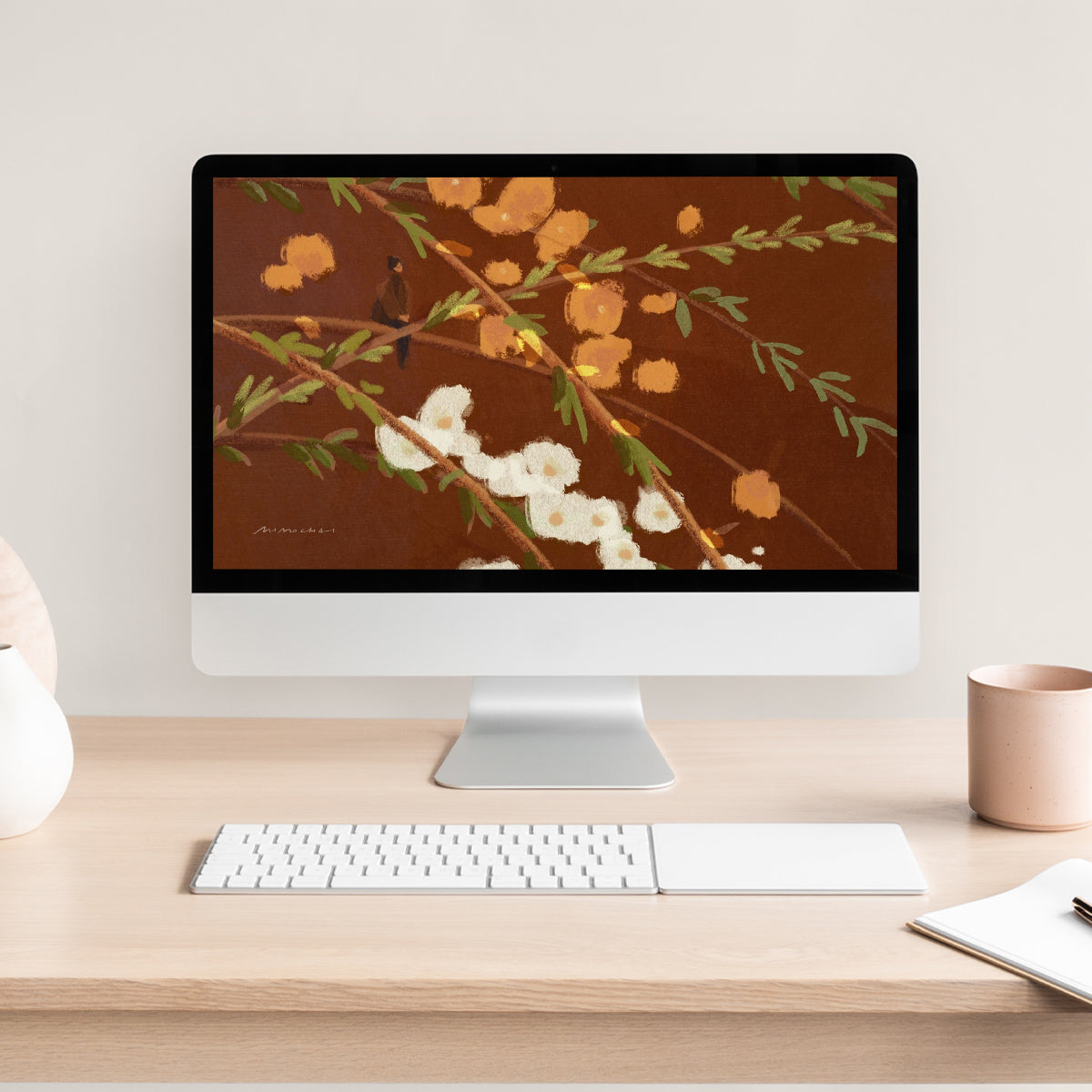 Computer monitor with floral wallpaper on a wooden desk