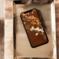 Smartphone with floral screen on a metallic surface