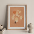 A framed art print of a girl releasing floating lanterns into an orange sky - zen art for home decor