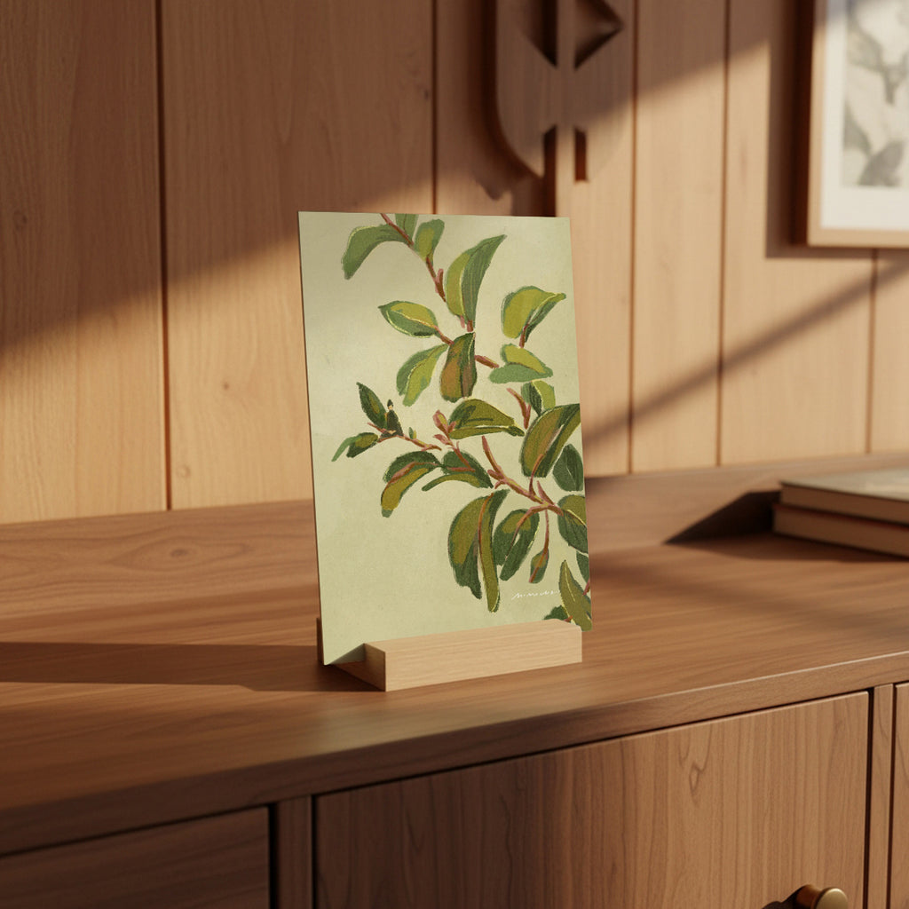 Card with green leaf design on a wooden stand against a wooden wall.