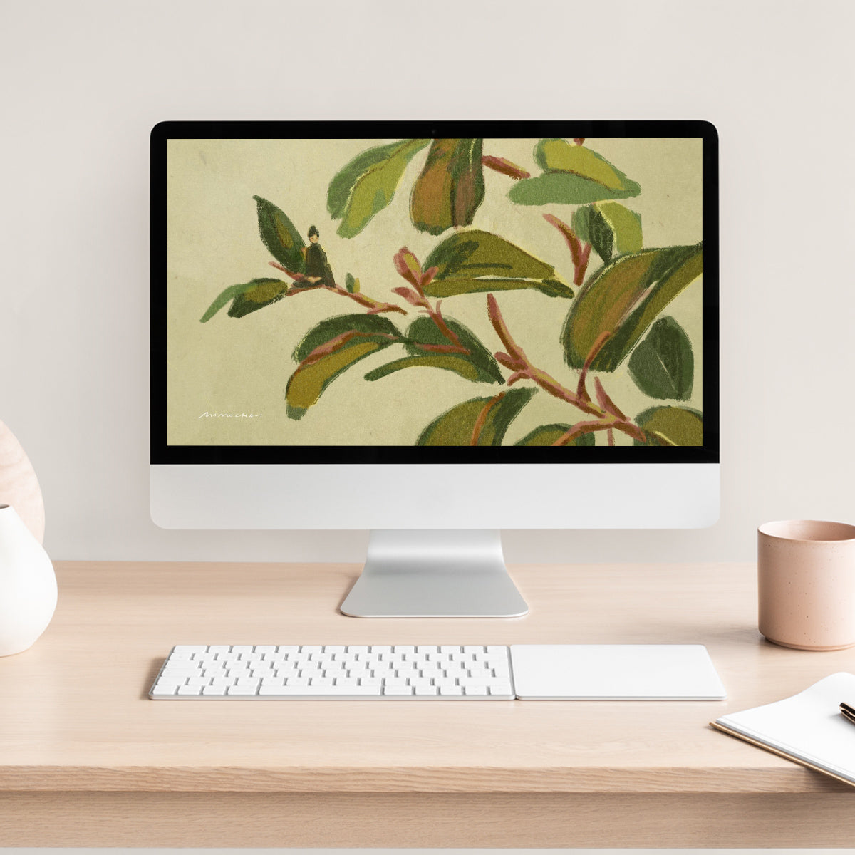 Computer monitor on a desk displaying a nature-themed wallpaper, with a keyboard and mug in the foreground.