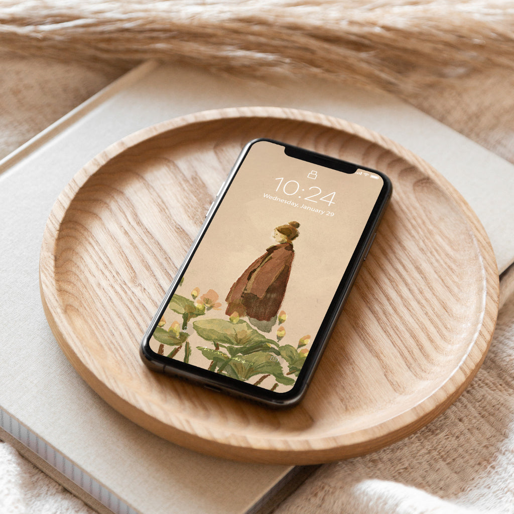 Smartphone with a nature-themed Mimochai Lotus Walk wallpaper on a wooden plate