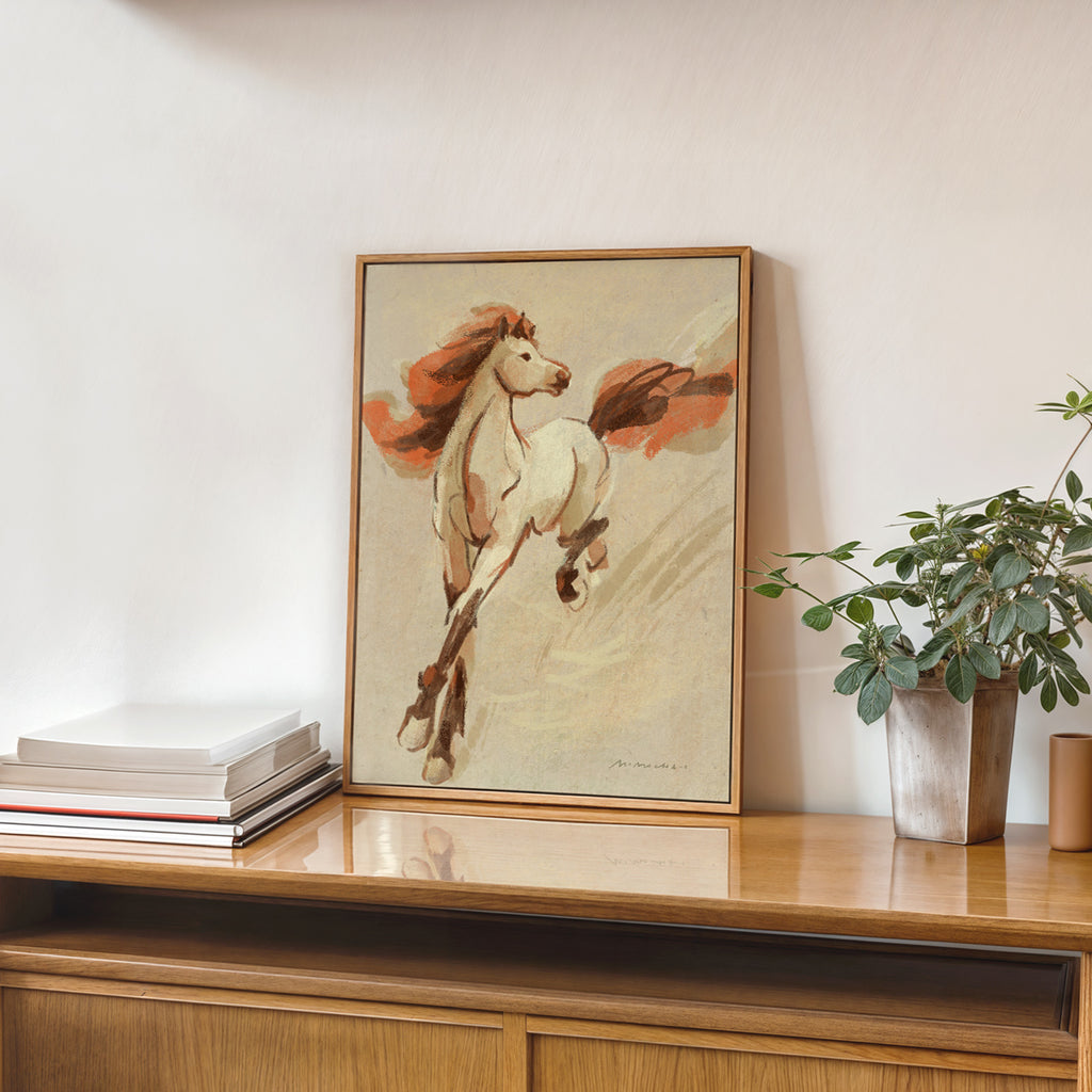 Framed artwork of a horse on a wooden surface with a plant in the background