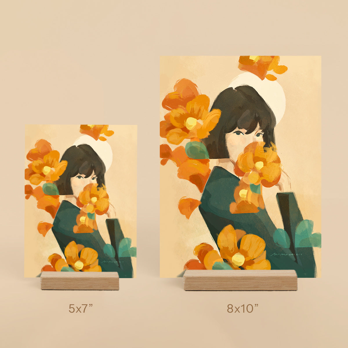 Two illustrated prints of a woman with flowers, one 5x7" and one 8x10" on a beige background.