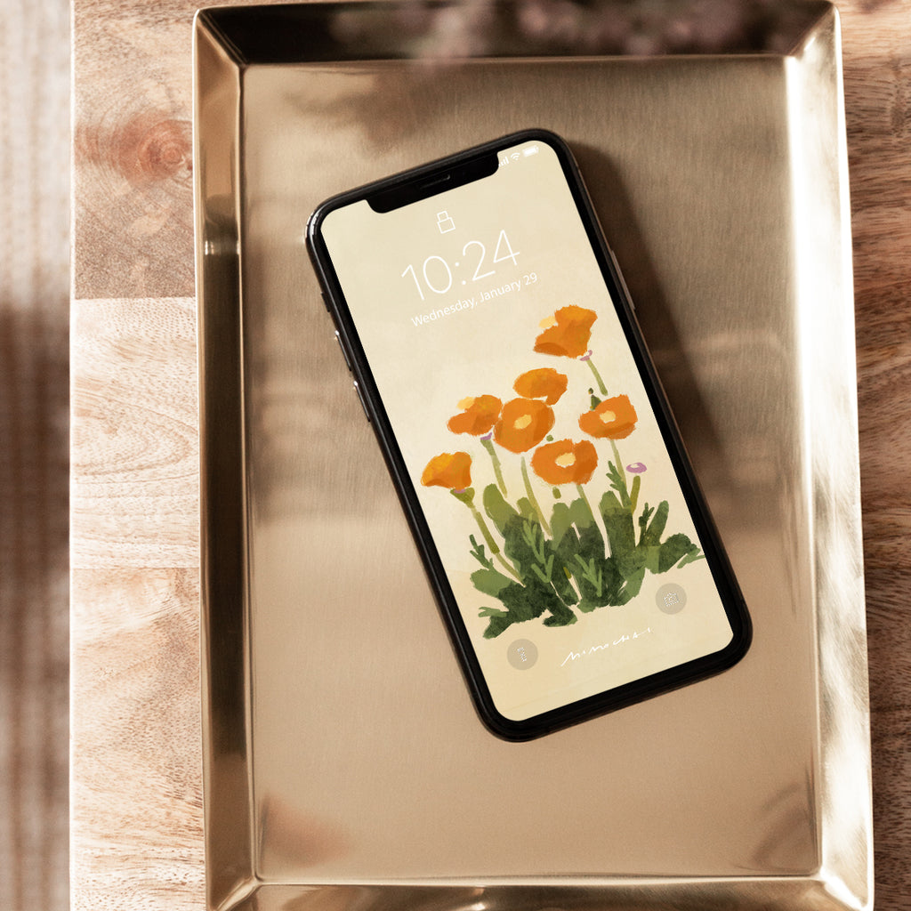 Phone with floral screen on a metallic tray