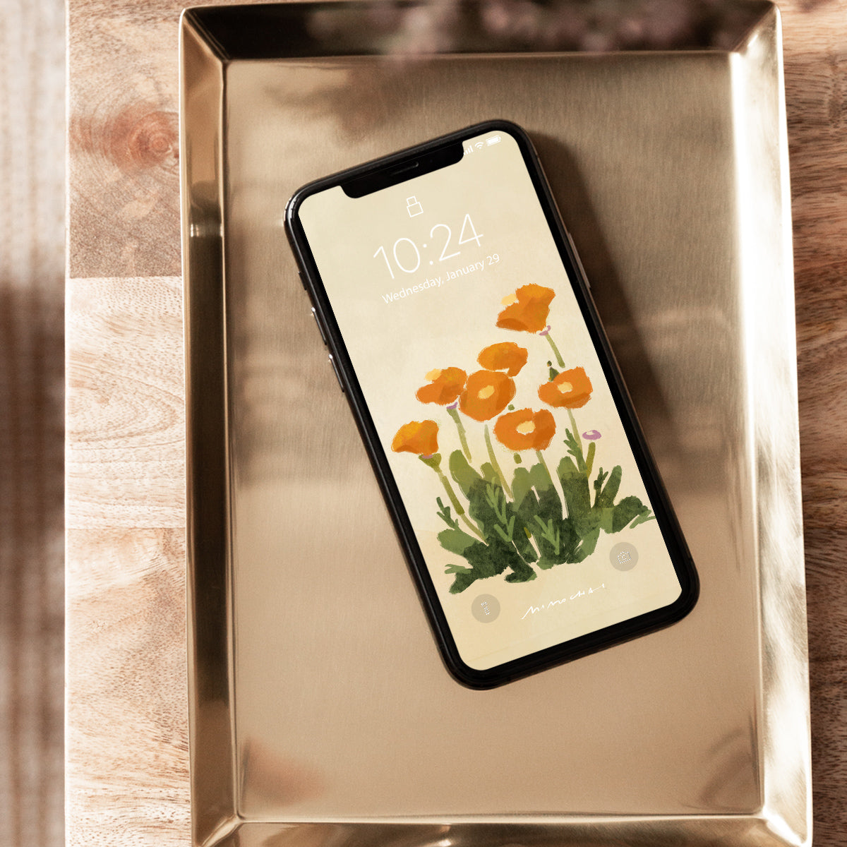 Phone with floral screen on a metallic tray