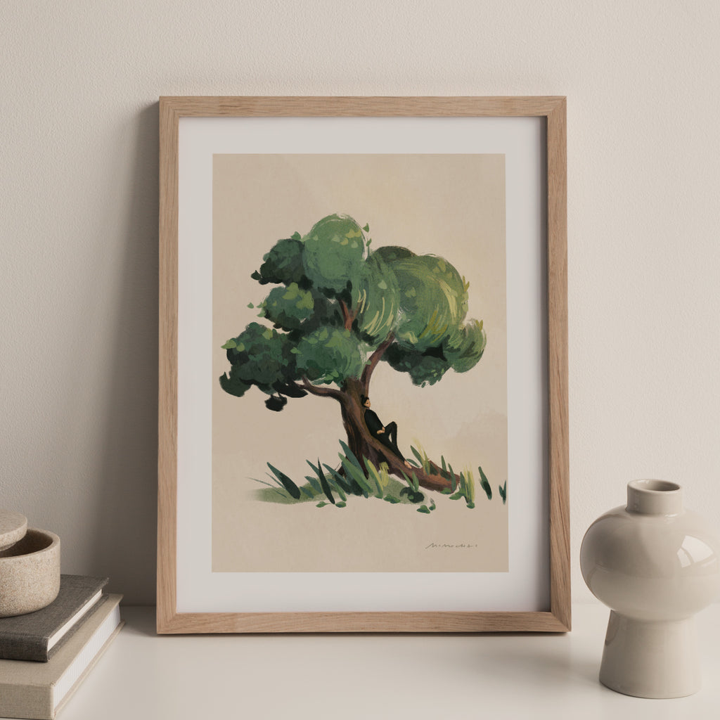 Framed artwork of a tree on a beige wall with decorative items.
