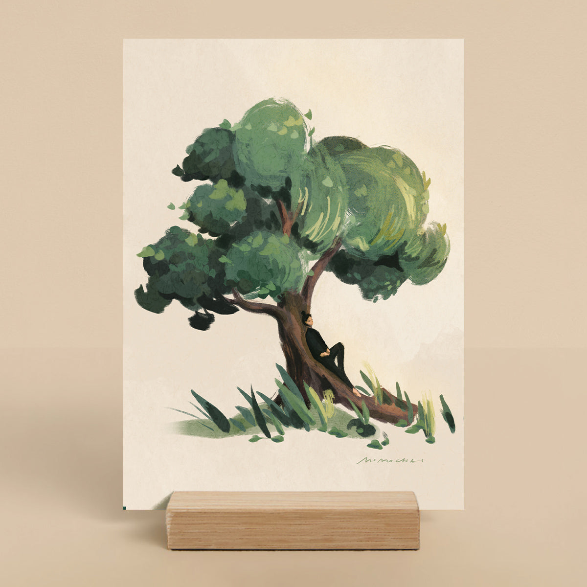 Art print of a tree with a person sitting under it on a beige background
