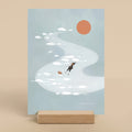 Illustration of a person and dog floating in a blue river with the sun in the sky, displayed on a beige background.