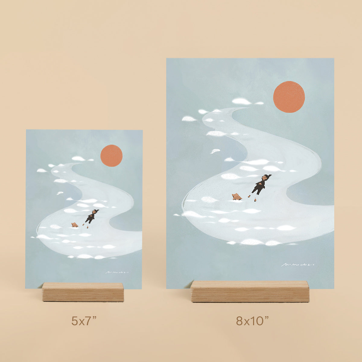 Two blue art prints of a person and their dog floating in a river, peacefully resting in the sun. 