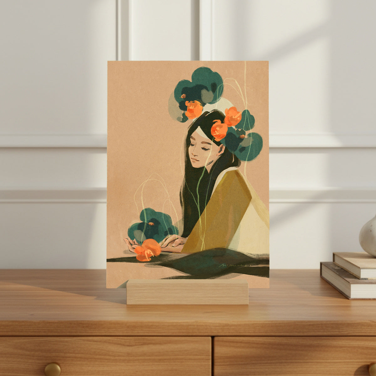 Art print of a woman with flowers in her hair on a wooden surface.