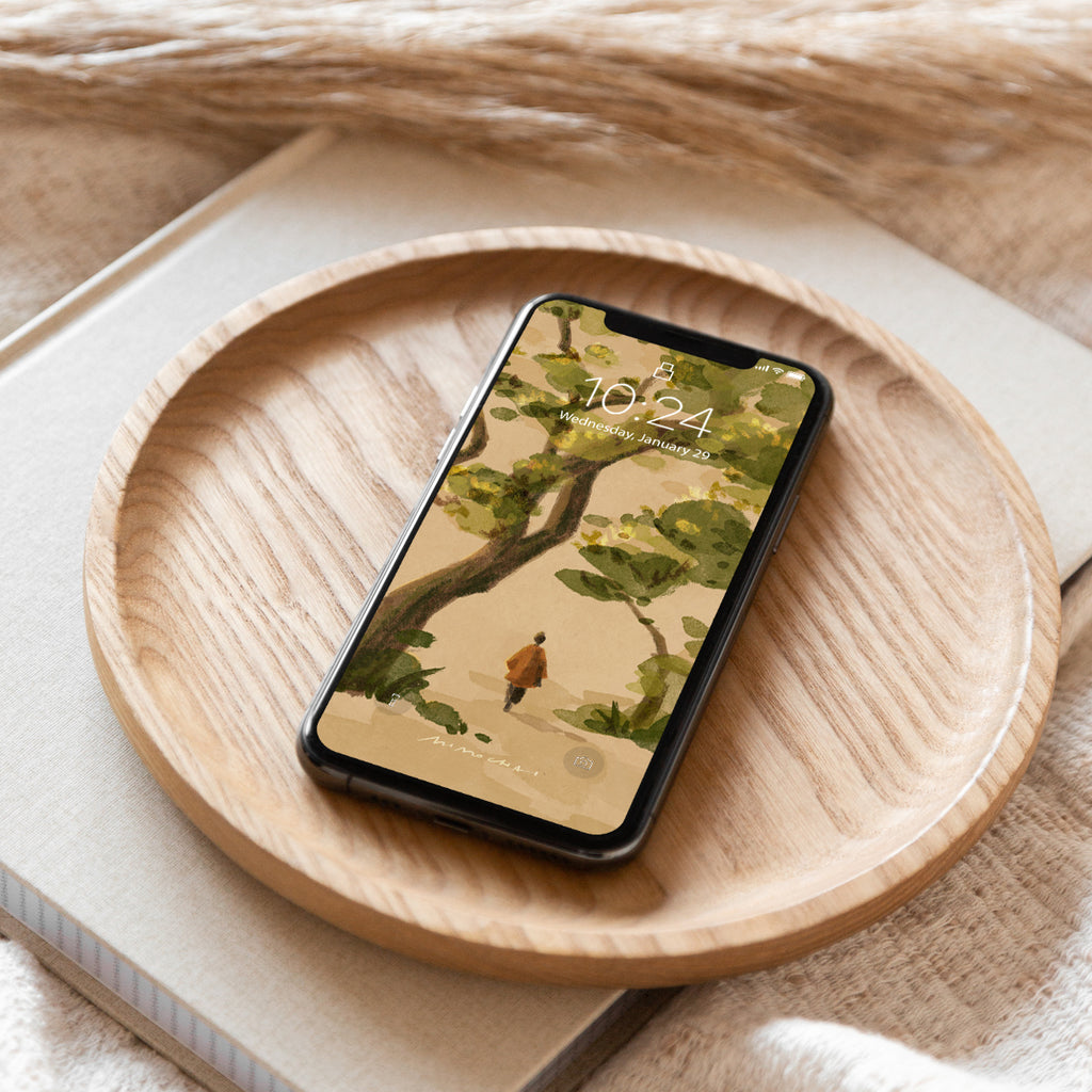 Smartphone with nature-themed wallpaper of a person walking under oak trees