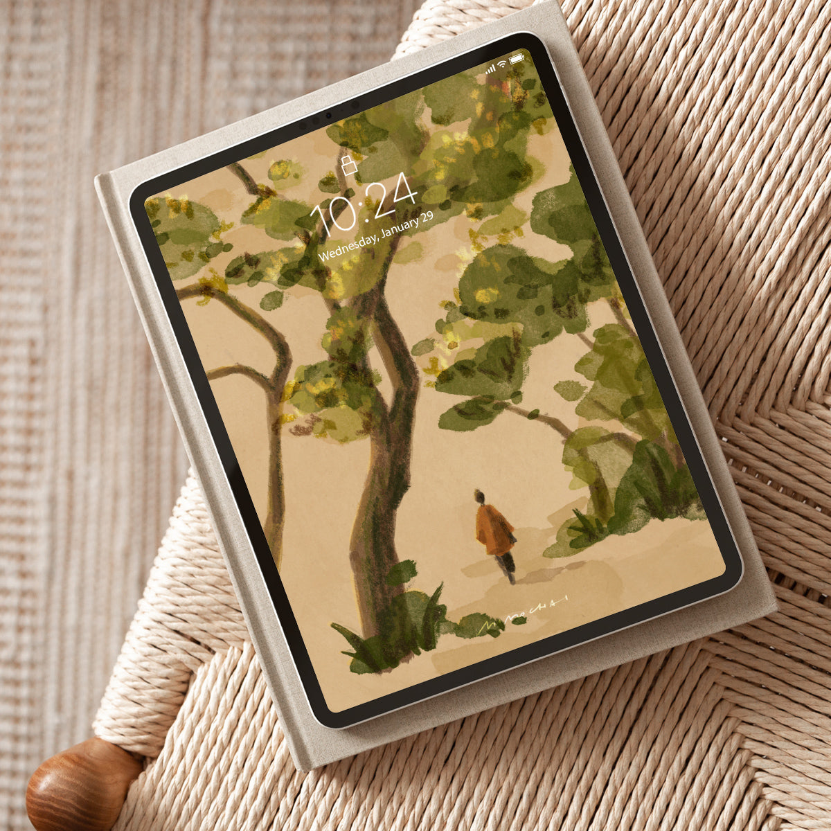 Tablet with a nature-themed wallpaper of a person walking under trees