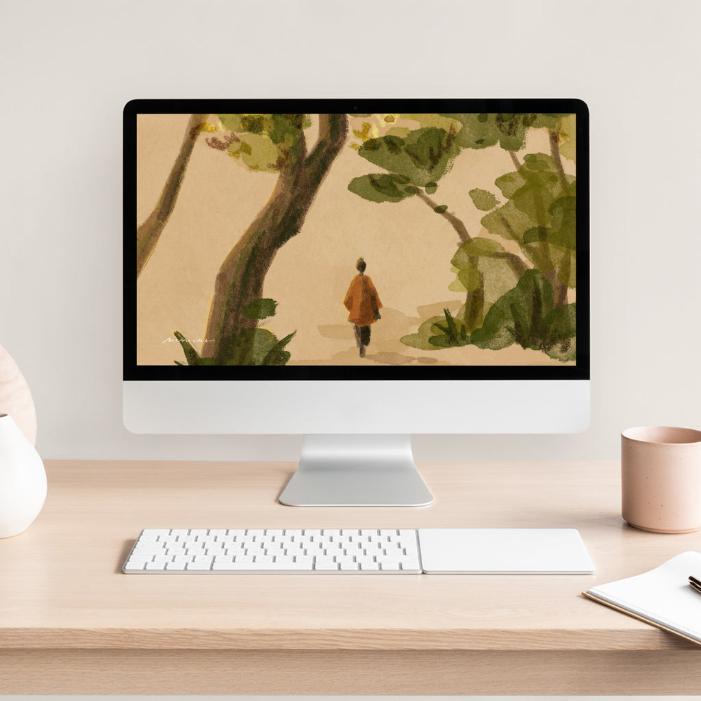 Computer monitor on a desk with a nature-themed wallpaper