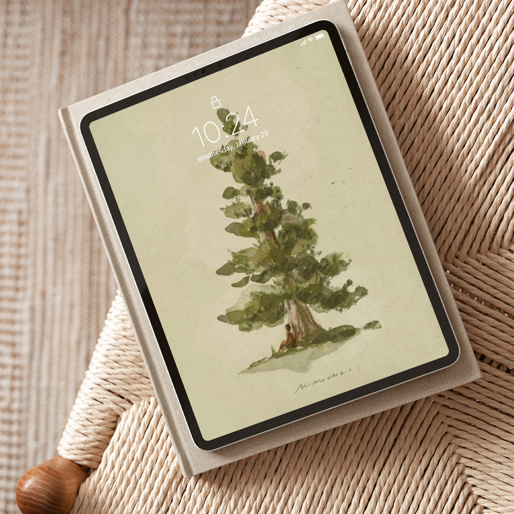 Tablet with a tree illustration on the screen, placed on a textured surface.