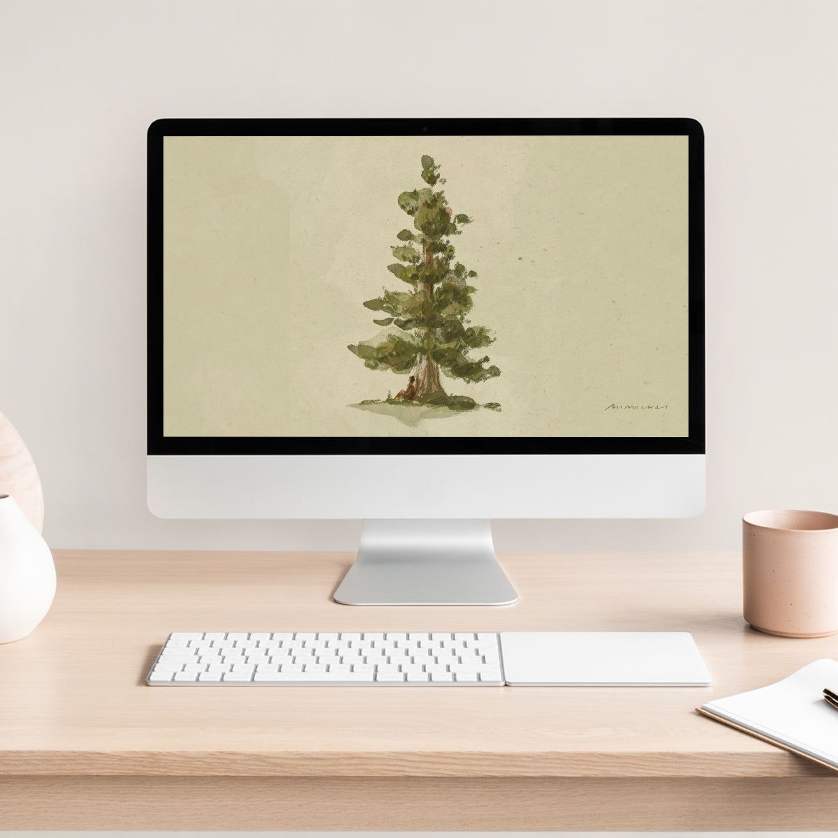 Computer monitor displaying a tree image on a desk with a keyboard and mug.