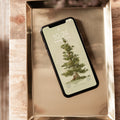 Phone with a nature-themed wallpaper with a tree on a metallic tray