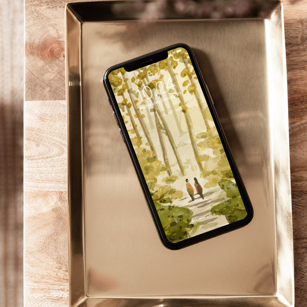 Phone with nature-themed case on a metallic tray