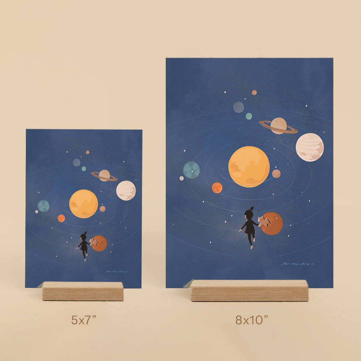 Two framed illustrations of planets and a little girl on a beige background